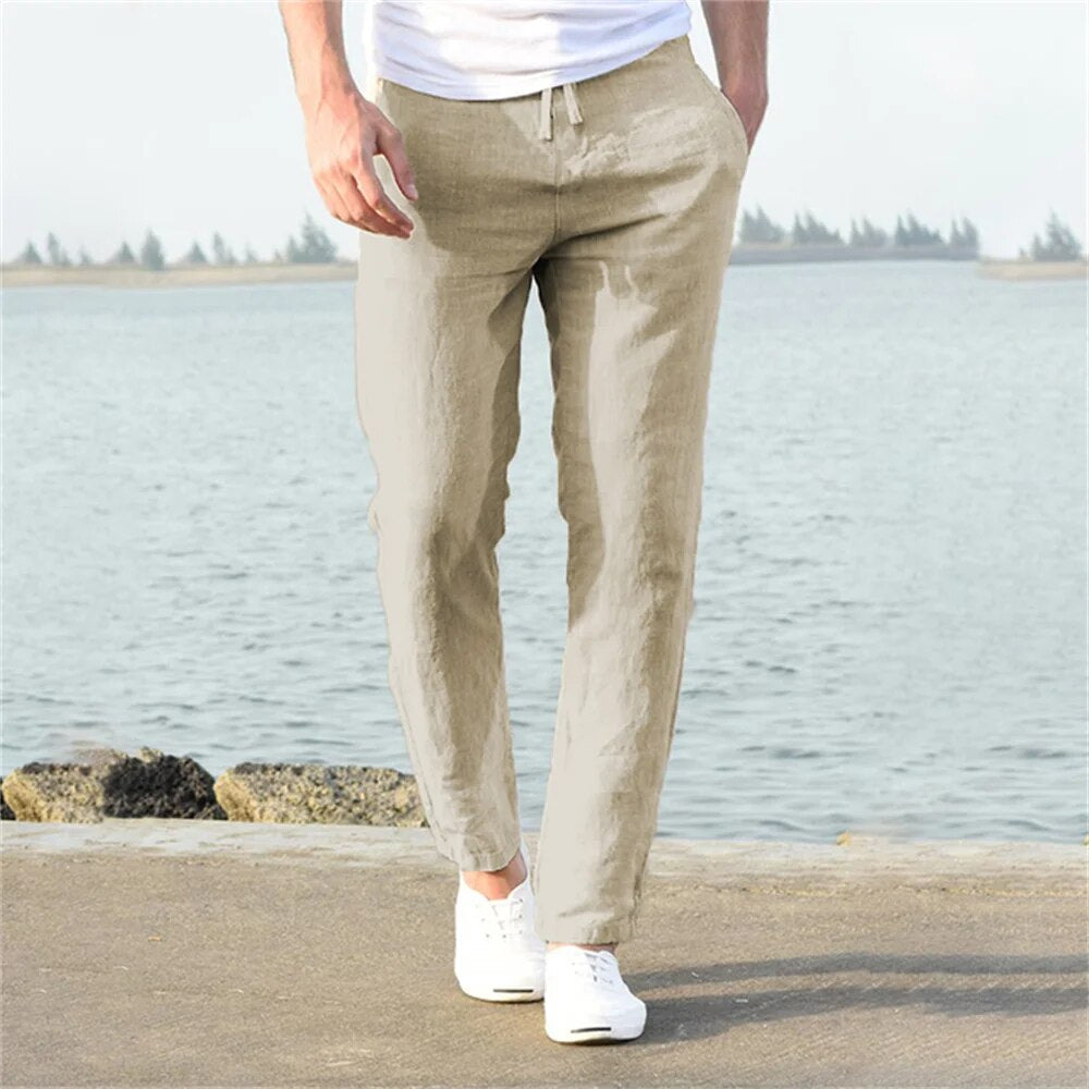 Model wearing tapered linen pants in white – TARLANO
